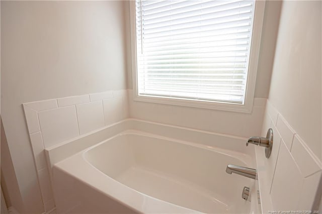 bathroom with a garden tub