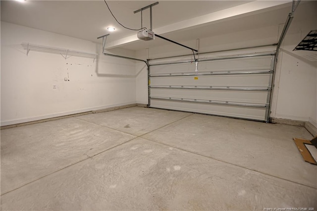 garage with a garage door opener and baseboards