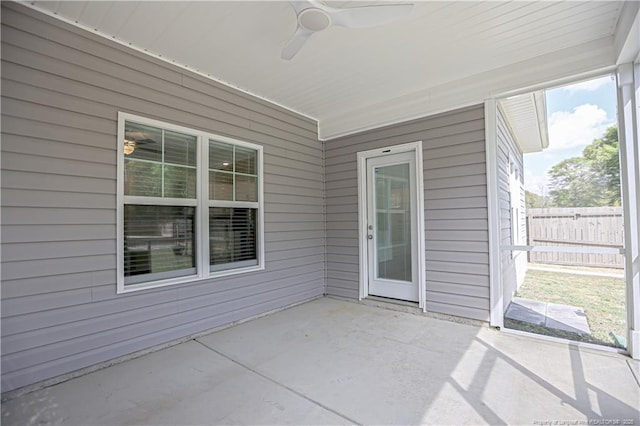 unfurnished sunroom featuring ceiling fan