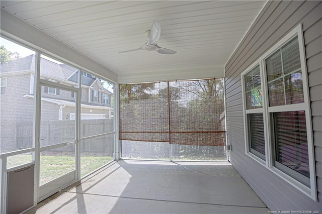 unfurnished sunroom featuring plenty of natural light and a ceiling fan