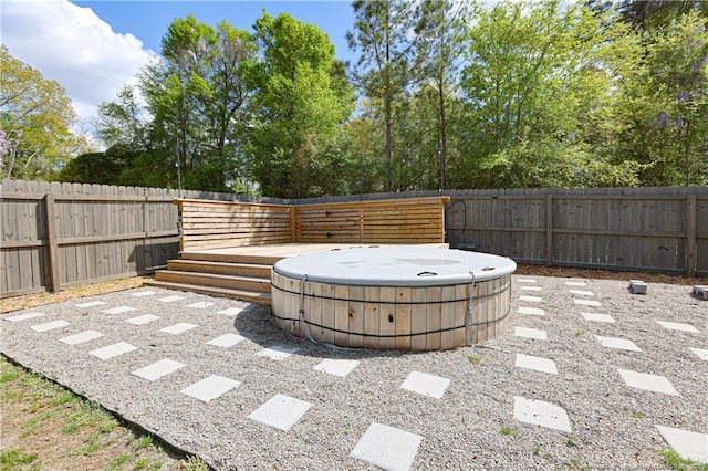 view of patio / terrace with a hot tub and a fenced backyard