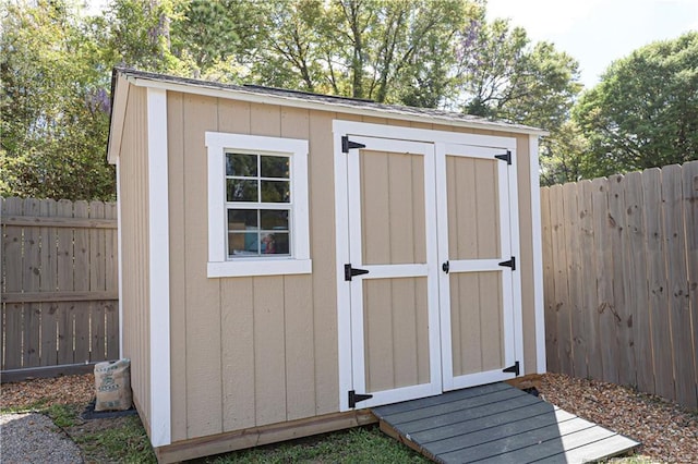 view of shed with a fenced backyard