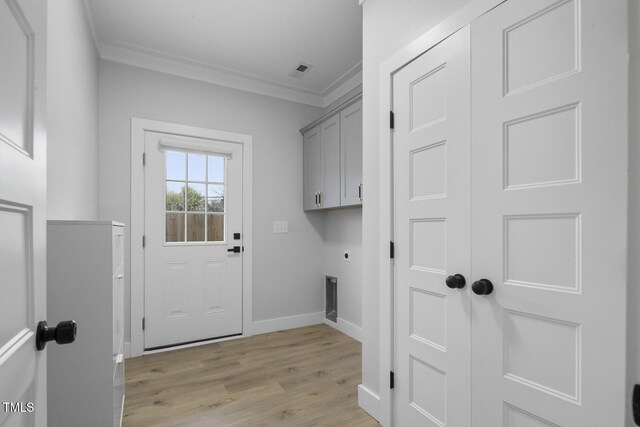 clothes washing area with light wood finished floors, baseboards, ornamental molding, cabinet space, and electric dryer hookup