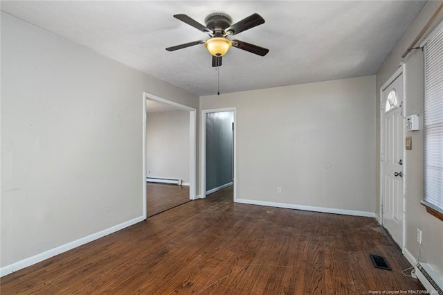 unfurnished room with wood finished floors, visible vents, a baseboard radiator, ceiling fan, and a baseboard heating unit