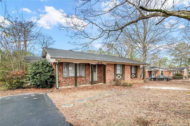 ranch-style home featuring brick siding