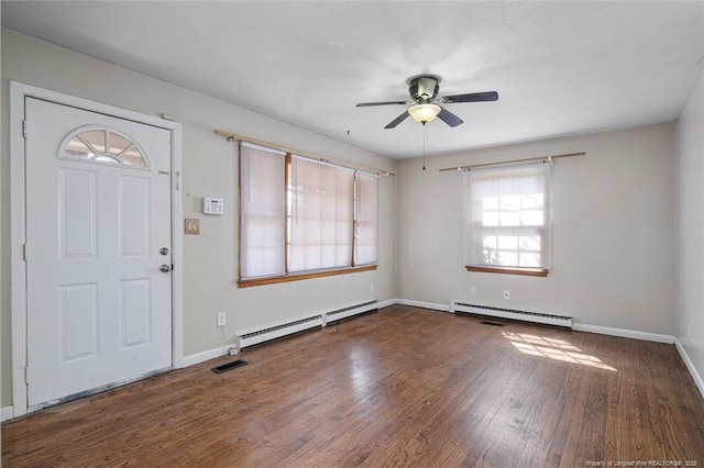 entryway with a baseboard radiator, visible vents, ceiling fan, and wood finished floors