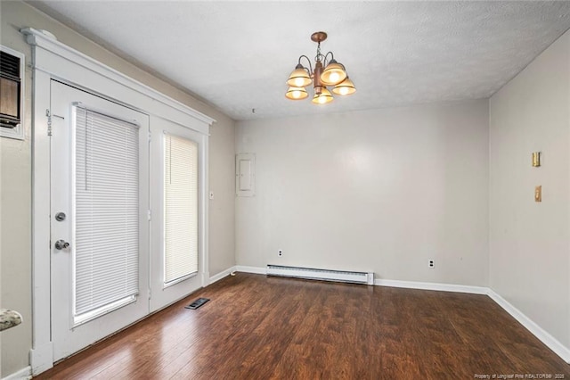 spare room with visible vents, a baseboard radiator, baseboards, wood finished floors, and a notable chandelier