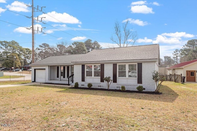 1803 Saint Paul Ave, Fayetteville, NC 28304 - ranch-style house with a front yard, an attached garage, a shingled roof, concrete driveway, and brick siding