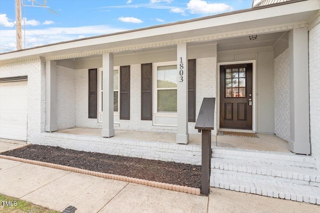 1803 Saint Paul Ave, Fayetteville, NC 28304 - doorway to property with a garage, brick siding, and covered porch