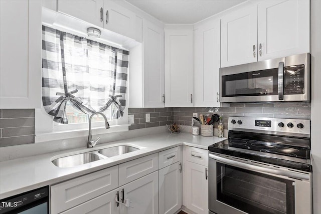 1803 Saint Paul Ave, Fayetteville, NC 28304 - kitchen featuring a sink, decorative backsplash, appliances with stainless steel finishes, and white cabinets