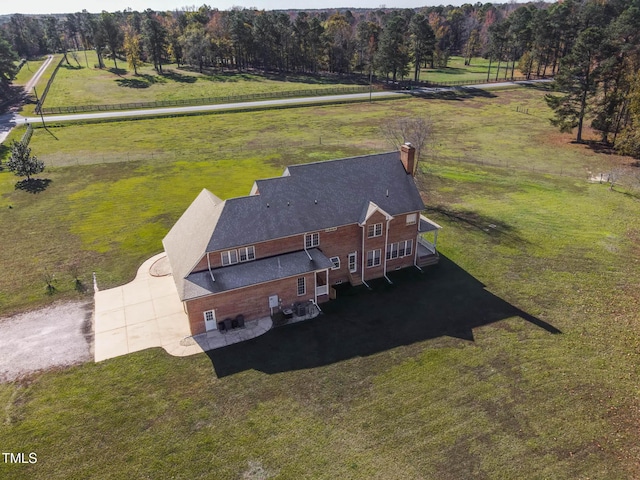 drone / aerial view featuring a rural view and a forest view