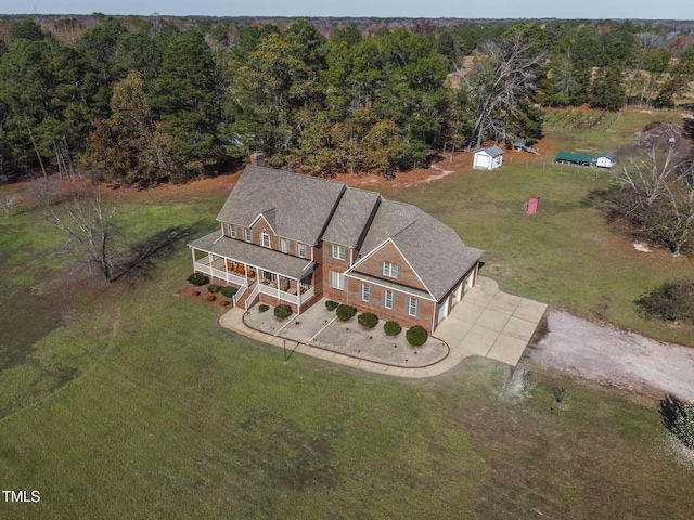 bird's eye view featuring a wooded view