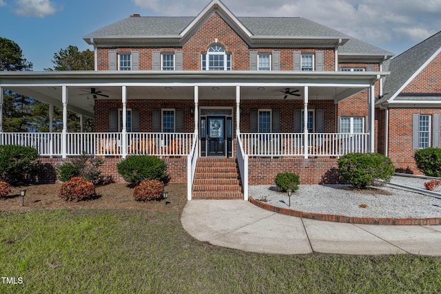 view of front facade featuring brick siding, a porch, and a ceiling fan