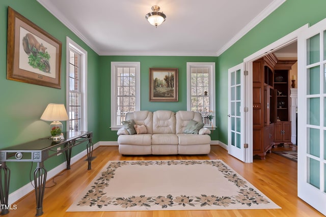 living room with french doors, wood finished floors, baseboards, and ornamental molding