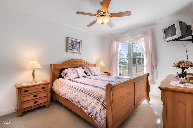 bedroom with ceiling fan, baseboards, light colored carpet, and ornamental molding