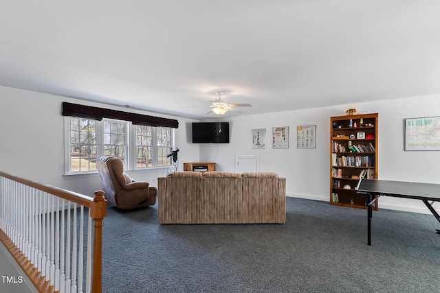 living area with baseboards, ceiling fan, and dark colored carpet