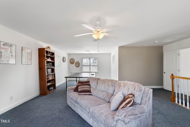 living area with dark carpet, baseboards, and ceiling fan