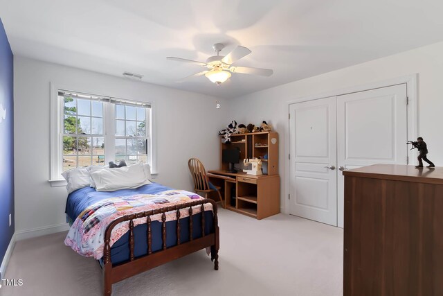 bedroom featuring visible vents, light carpet, a closet, and ceiling fan