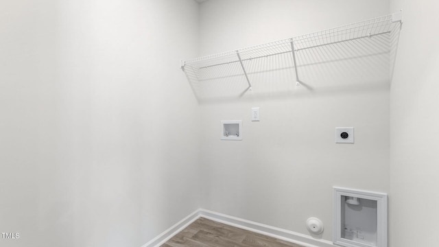 clothes washing area with baseboards, laundry area, hookup for a washing machine, hookup for a gas dryer, and hookup for an electric dryer