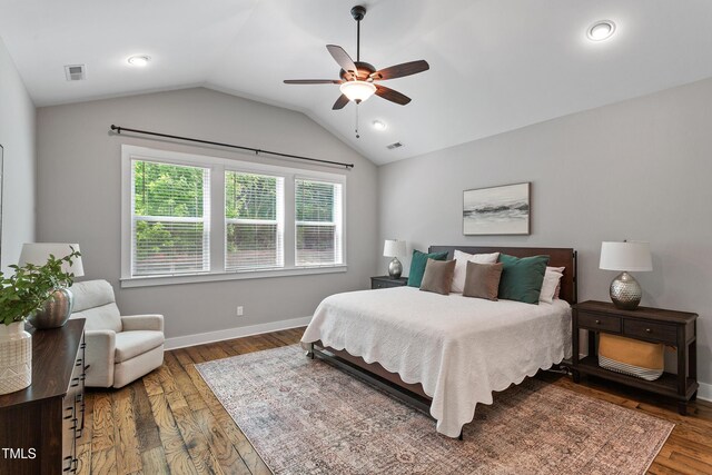 bedroom with ceiling fan, baseboards, wood finished floors, lofted ceiling, and visible vents
