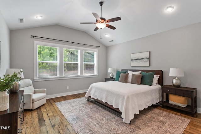 bedroom featuring visible vents, a ceiling fan, baseboards, wood finished floors, and vaulted ceiling