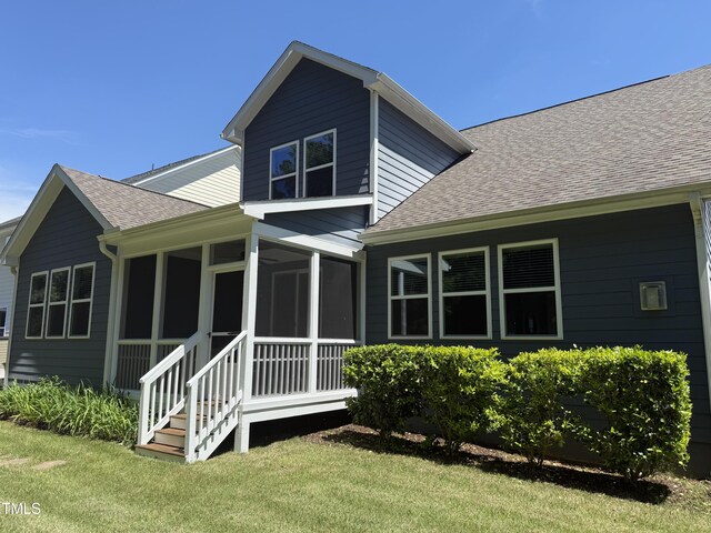 1564 Highpoint St, Wake Forest, NC 27587 - back of house featuring roof with shingles, a yard, and a sunroom
