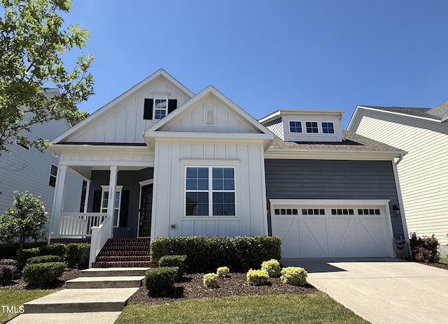 1564 Highpoint St, Wake Forest, NC 27587 - view of front of home with board and batten siding, covered porch, driveway, a garage, and a shingled roof