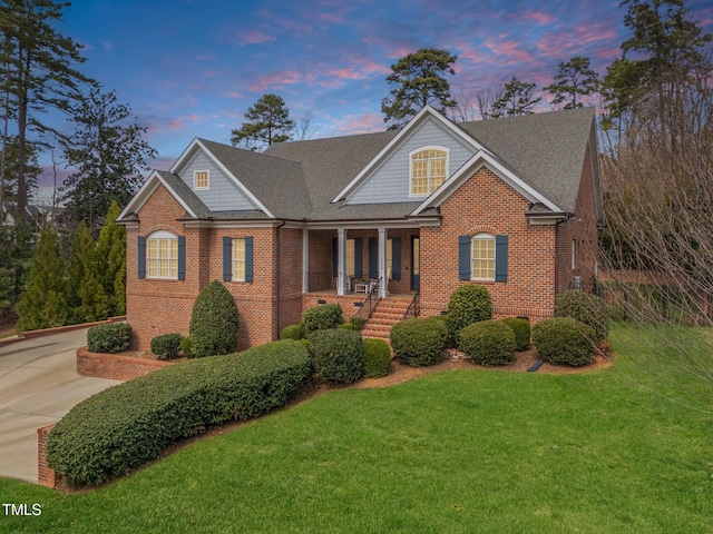 3204 Cobblestone Ct, Raleigh, NC 27607 - view of front of property with brick siding, a front lawn, and a porch