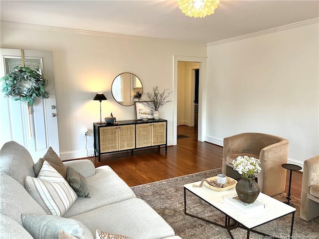 living room with baseboards, wood finished floors, and ornamental molding