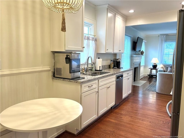 kitchen featuring white cabinets, dark wood-style floors, appliances with stainless steel finishes, and a sink