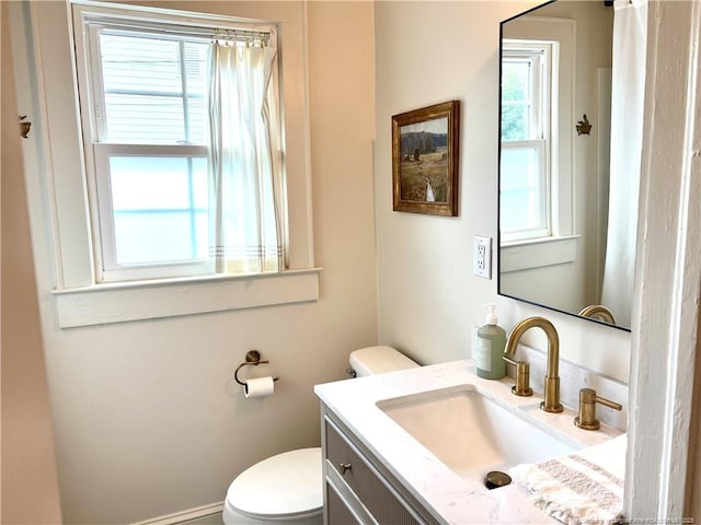 bathroom featuring toilet and vanity