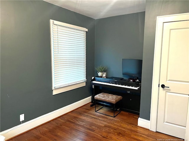 office area with baseboards and wood finished floors