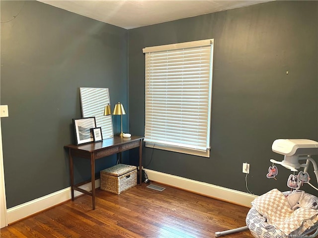 office with visible vents, baseboards, and wood finished floors