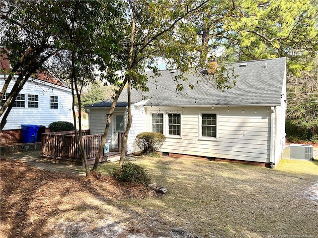 rear view of house featuring crawl space, a wooden deck, central AC unit, and a shingled roof