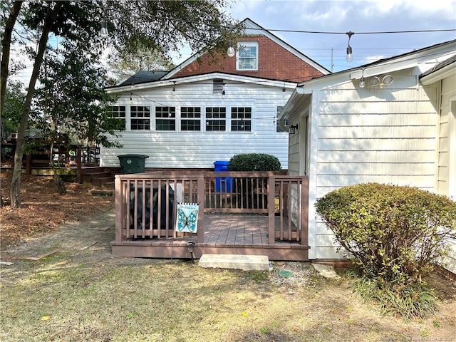 back of property featuring a wooden deck