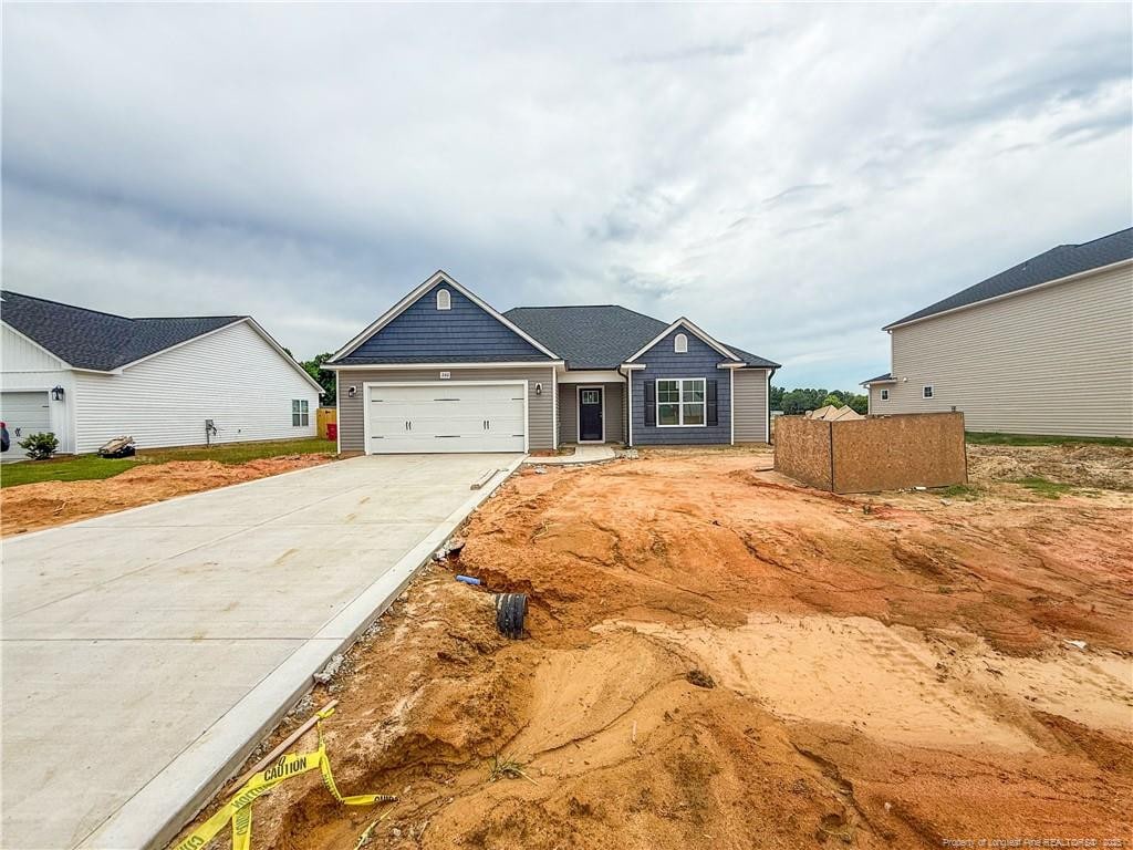 266 Guard Ln, Parkton, NC 28371 - craftsman-style house with concrete driveway and a garage