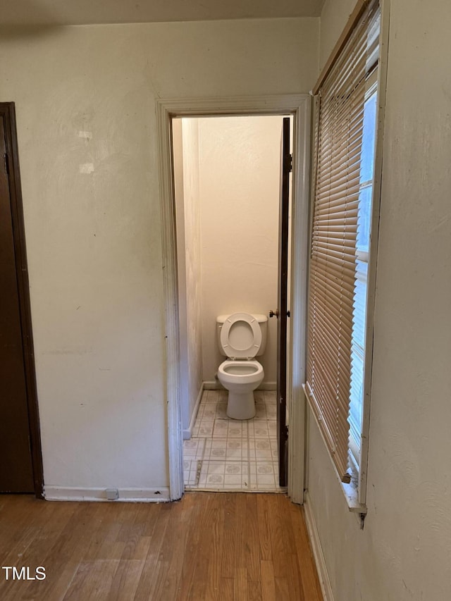 bathroom featuring toilet and wood finished floors