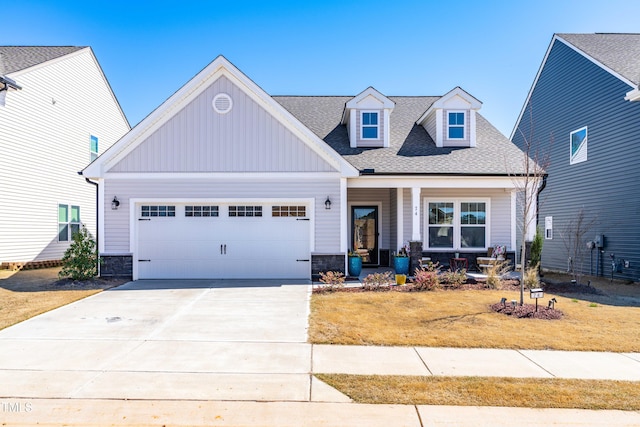 74 Silver Moon Ln, Clayton, NC 27527 - craftsman house with a garage, stone siding, covered porch, and driveway