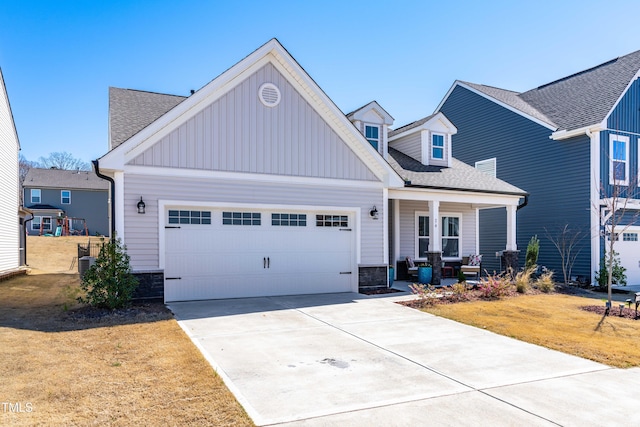 74 Silver Moon Ln, Clayton, NC 27527 - view of front of property with a front yard, driveway, roof with shingles, a garage, and stone siding