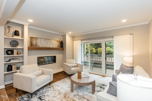 700 Bishops Park Dr Unit 205, Raleigh, NC 27605 - living room featuring a glass covered fireplace, crown molding, wood finished floors, recessed lighting, and baseboards