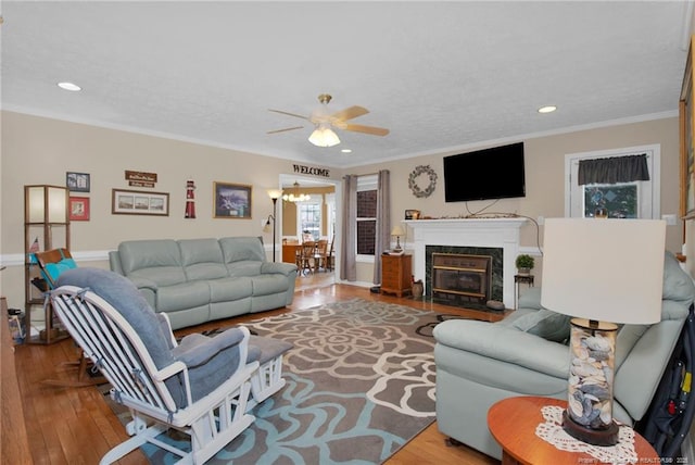 living room featuring crown molding, recessed lighting, wood finished floors, and ceiling fan