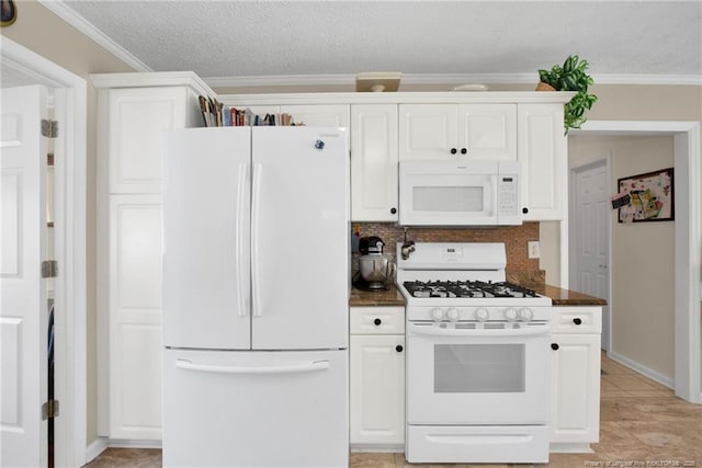 kitchen with dark countertops, crown molding, decorative backsplash, white appliances, and white cabinetry