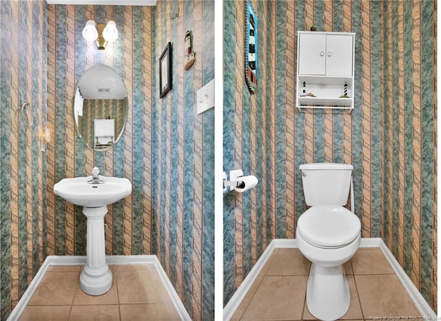 half bath with tile patterned floors, toilet, wallpapered walls, and baseboards