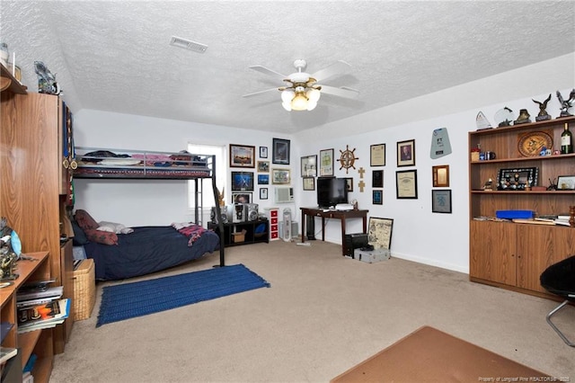 bedroom with visible vents, carpet floors, and a textured ceiling