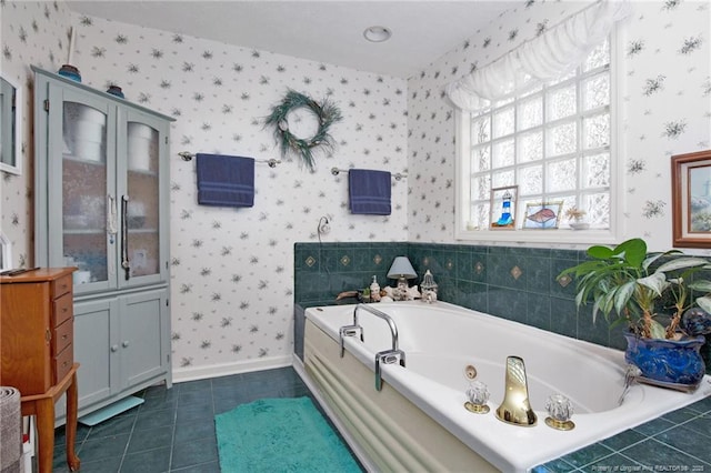 bathroom featuring tile patterned floors, a tub with jets, wallpapered walls, and baseboards