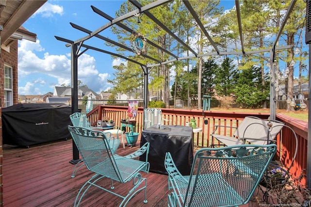 wooden terrace featuring a grill and a pergola