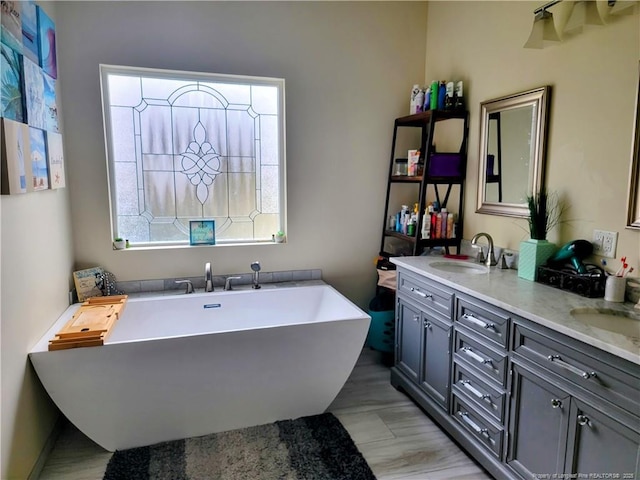 41 Lenor Dr, Lumberton, NC 28360 - full bath featuring double vanity, a soaking tub, wood finished floors, and a sink