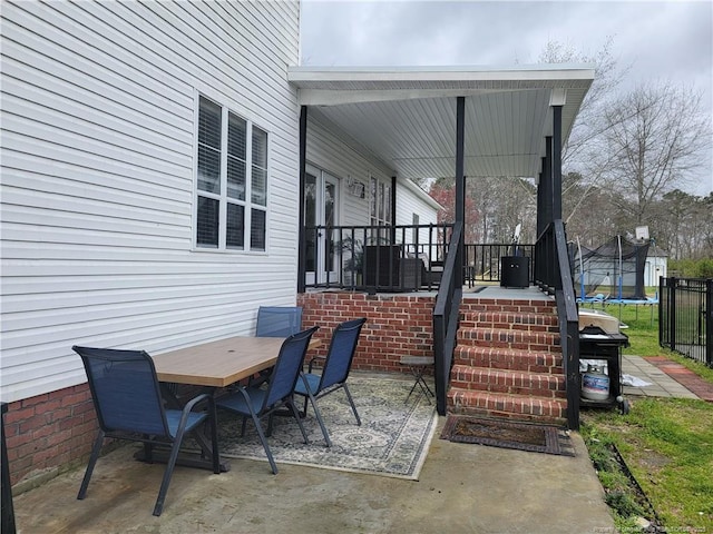 41 Lenor Dr, Lumberton, NC 28360 - view of patio featuring outdoor dining area and a trampoline