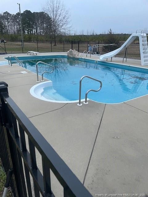41 Lenor Dr, Lumberton, NC 28360 - view of pool featuring a patio area, a fenced in pool, a water slide, and fence