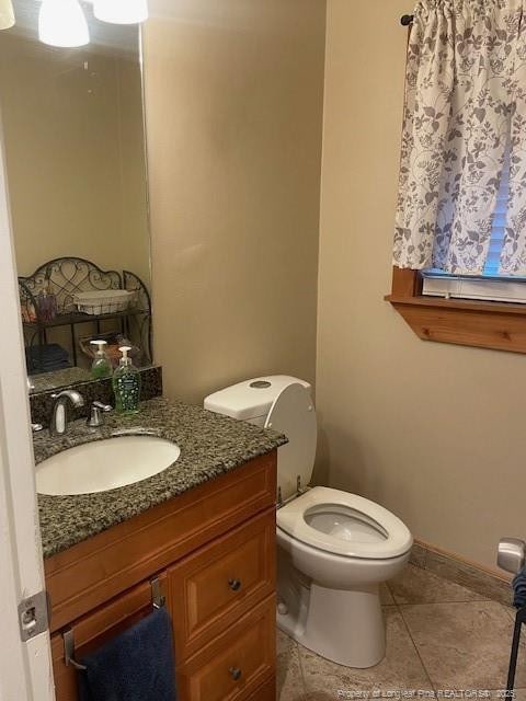 41 Lenor Dr, Lumberton, NC 28360 - half bathroom with tile patterned floors, baseboards, toilet, and vanity